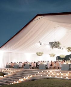 an outdoor event with candles lit up on the steps