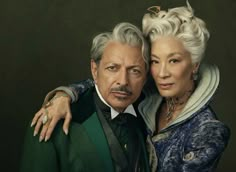 an older man and woman pose for a portrait