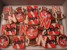 decorated cookies in the shape of footballs and letters