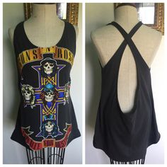 the back of a black tank top with skulls and crosses on it, next to a mannequin