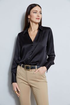 Nothing beats the chic factor and luxe patina of a Silk Satin shirt. Our button-down design features a v-neckline that is perfect for layering under a blazer or wearing on its own- you will live in this shirt all season long. Elie Tahari Exclusive Long Sleeve Silk Satin Button Down shirt 100% Silk Relaxed Fit; Runs true to size. Model is 5'9" and wearing size S Length From Shoulder to Hem: Back 26"L, Sleeve 32.5"L (approx. length for size S) Dry Clean Only Imported Style #: E107G513 Modern Black Blouse For Business Casual, Sleek Business Casual Blouse For Fall, Sleek Office Tops With Button Closure, Luxury Tops With Lapel Collar For Office, Elegant Tops With Button Cuffs For Night Out, Luxury Lapel Collar Tops For Office, Sleek Tops With Lapel Collar For Workwear, Luxury Lapel Collar Top For Workwear, Sleek Workwear Tops With Buttons