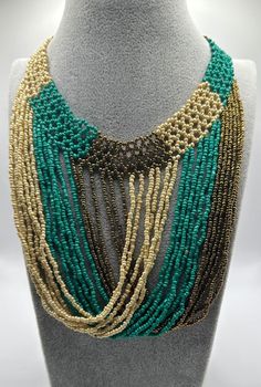 Discover the elegance of handcrafted jewelry made by native Ecuadorian women artisans using traditional techniques. Each unique piece supports sustainable income for these communities. Wear our necklaces to embrace rich cultural heritage and make a difference. Explore our collection today! Artisan Handwoven Adjustable Jewelry, Artisan Long Necklace For Festivals, Artisan Adjustable Natural Necklaces, Artisan Adjustable Natural Necklace, Traditional Green Adjustable Necklace, Artisan Adjustable Natural Color Necklaces, Unique Fair Trade Jewelry For Festivals, Unique Long Beaded Necklace, Unique Handmade Natural Necklaces