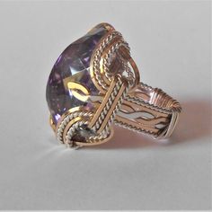 "Bold Handmade Sterling Silver Wire Wrapped Genuine Amethyst Ring Stunning Deep Purple Birthstone for February Sizing and shipping is ALWAYS FREE with a 14 day \"No Questions Asked\" return policy. lifetime warranty, free sizing and cleaning for life for life. All these are explained in the description below or feel free to reach out to us. Gemstone sizes available: S (18x13mm 3/4x1/2 inch 10+ct) This ring is made with real gems. I made it myself, so if you see a setting you like and want a diff Gold Amethyst Ring With Large Stone As Gift, Dazzling Topaz Ring With Gemstone Accents As Gift, Formal Amethyst Jewelry With Large Stone, Formal Large Stone Amethyst Jewelry, Wire Wrapped Crystal Ring For Anniversary, Handmade Oval Crystal Ring In Fine Jewelry Style, Handmade Oval Crystal Ring Fine Jewelry, Elegant Wire Wrapped Crystal Ring For Anniversary, Handmade Silver Luxury Crystal Ring