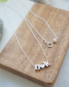 "Personalized letter necklace- Couples Initials Necklace, Tiny letter necklace, Couples necklace, Gift for girlfriend, Valentine's Day Gift, Minimal Necklace, personalized necklace Features: -------------- - rhodium plated charms (hearts and letters) - lowercase block letters - sterling silver chain Personalize this adorable necklace with you and your loved one's initials. Pick the 2 initials from the drop down menu and let me know the length of the chain, up to 19 inches at no additional cost. Initial Pendant Charm Necklace For Anniversary, Anniversary Gift Initial Pendant Charm Necklaces, Anniversary Gift Initial Pendant Charm Necklace, Initial Pendant Charm Necklaces For Anniversary, Dainty Initials Necklace For Anniversary, Name Initial Necklace For Anniversary And Mother's Day, Mother's Day Personalized Initial Necklace With Letter Beads, Gift Initial Pendant Charm Necklace With Letter Beads, Mother's Day Personalized Gift Initial Necklace With Letter Beads