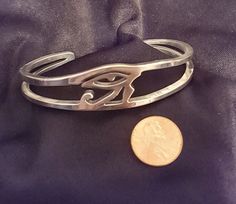 Eye of Horus recycled aluminum cuff bracelet may be ordered in small, medium and large sizes. Known in Egypt as The One Far Above, Horus represents protection, healing and restoration. Earrings, pendant necklace and link bracelet are also available. our cuff bracelets are made to order and we need your size FIRST just wrap string around the wrist then measure the string and send us a message - we'll respond with your size - check your messages for follow-up Thanks! Spiritual Stainless Steel Nickel-free Jewelry, Symbolic Round Cuff Bracelet Gift, Symbolic Hypoallergenic Metal Jewelry, Spiritual Hypoallergenic Bangle Jewelry, Unique Hypoallergenic Metal Jewelry, Nickel-free Symbolic Metal Bracelets, Hand Forged Metal Cuff Bracelet As Gift, Nickel-free Silver Stainless Steel Cuff Bracelet, Spiritual Hand Forged Cuff Bracelet Gift