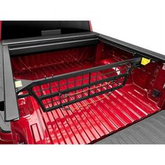 the back end of a red truck with its cargo cage open and it's bed in