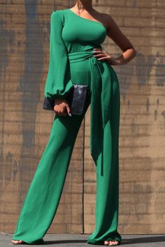 One Shoulder Jumpsuit - Dark Green This jumpsuit is a statement in itself! Perfect for date night or brunch with the ladies! This green jumpsuit comes in a wide pant leg featuring a long sleeve one shoulder, adjustable tie belt, and side zipper. Pair this with a stylish heel and handbag for a complete look. One Shoulde Chic Green Belted Jumpsuit, Chic Green Belted Jumpsuits And Rompers, Chic Belted Green Jumpsuits And Rompers, Chic Green Evening Jumpsuits And Rompers, Trendy Green Jumpsuits And Rompers For Fall, Chic Green Jumpsuits And Rompers For Night Out, Party Jumpsuits And Rompers With Tie Waist, Green Fitted Wide-leg Jumpsuits And Rompers, Green Wide Leg Jumpsuits And Rompers For Spring