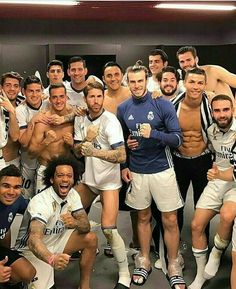 a group of men standing next to each other in front of a locker room door