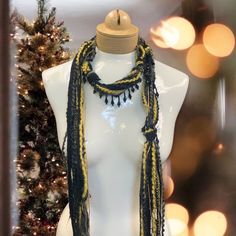 Discover this stunning bohemian beaded scarf necklace, crafted from luxurious Italian mohair yarn. The perfect lightweight accessory to elevate your holiday style. Features: Black and gold color combination Mohair yarn Italian craftsmanship Lightweight and comfortable Beaded details Linen gift pouch Benefits: Adds a touch of bohemian elegance to any outfit Perfect for the holiday season Luxurious and high-quality materials Versatile and can be worn in multiple ways Makes a thoughtful and stylish Bohemian Black Handmade Scarves, Bohemian Black Handmade Scarf, Black Bohemian Scarf For Festive Occasions, Black Bohemian Scarves For Festive Occasions, Handmade Black Scarves As Gifts, Bohemian Handmade Scarves For Festive Occasions, Handmade Bohemian Scarves For Festive Occasions, Gold Color Combination, Beaded Scarf