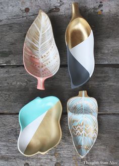 four different colored ceramic dishes sitting on top of a wooden table