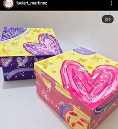 two colorful boxes with hearts painted on them