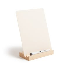 a wooden easel with a white board on it's side and a pen in the middle