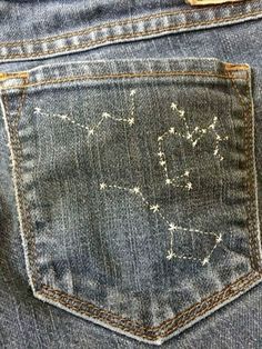 the back pocket of a pair of jeans with stars on them