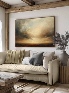 a living room filled with furniture and a painting on the wall