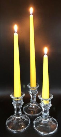 three clear candlesticks sitting on top of each other