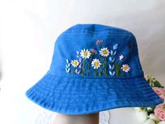 PRODUCT DETAILS This Bucket Hat will shield you from the sun on hot summer days. Decorated with a trendy embroidery design, it's the perfect combination of practicality, comfort, and style.  🌸MATERIAL: Cotton My product is one of our most popular options--it's perfect for the great outdoors and everyday use. Cotton absorbs sweat well, cool so bring a sense of comfort to the wearer.  Protect their heads and eyes in style. Pair with a jacket or camp shorts to make a statement. 🌸 SHIPPING: - To U Handmade Casual Sun Hat For Spring, Casual Handmade Sun Hat For Spring, Blue Cotton Sun Hat For Spring, Summer Brimmed Hats With Embroidery, Cute Blue Sun Hat For Summer, Cute Blue Summer Sun Hat, Summer Embroidered Short Brim Hat, Embroidered Summer Hat With Short Brim, Cute Summer Cotton Bucket Hat