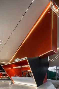 the interior of an office building with red and black accents