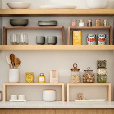 the shelves are filled with different types of food and kitchen utensils on them