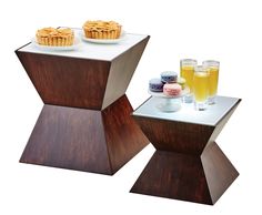 two wooden tables with cupcakes and drinks on them, one is shaped like a hexagonal box