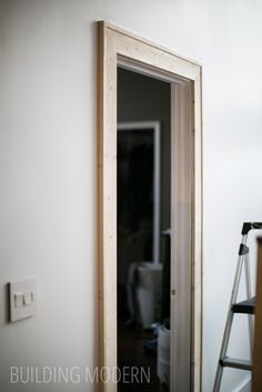 an empty room with a ladder leaning against the wall