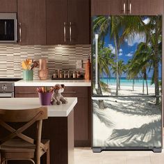 an open door with a beach scene and palm trees in the background on a kitchen counter