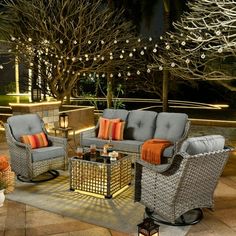 an outdoor patio with wicker furniture and lights