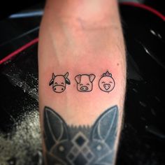 a person with a tattoo on their arm has three pigs in the shape of hearts