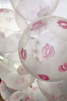 balloons with lipstick drawn on them in the shape of lips