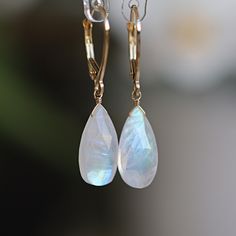 These Rainbow Moonstone Earrings feature breathtaking natural moonstones in a larger pear-cut shape in 14k Gold. Designed for those who adore statement earrings. Whether you are looking for a gift for a loved one born in June or simply treating yourself to a luxurious pair of earrings, these Dangle Moonstone Earrings are the perfect choice. MATERIALS: * 14k Gold (Yellow, Rose, White) * natural rainbow moonstone  * Leverback closure * beautiful branded gift box * card about moonstone SIZE: stones Moonstone Earrings Dangle, Moon Stone Earrings, Born In June, Earrings Teardrop, Moonstone Earrings, Moonstone Necklace, Moonstone Jewelry, Natural Rainbow, Box Card