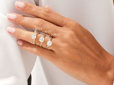 a woman's hand with three different rings on her left and the other one is wearing