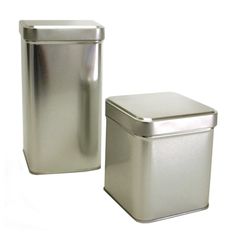 two stainless steel trash cans one is empty and the other has a lid on it