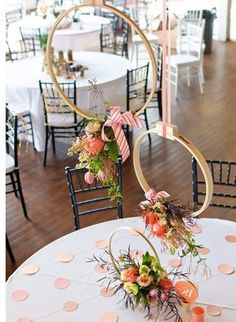 the tables are decorated with floral centerpieces and gold hoop decorations for an elegant touch