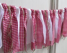 red and white gingham checkered fabric hanging from the side of a door