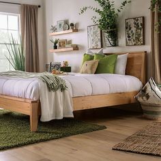 a bed room with a neatly made bed and green rugs on the wooden floor