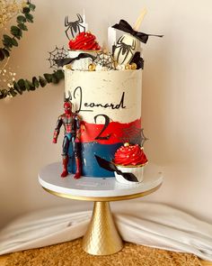 a spiderman themed cake on top of a table