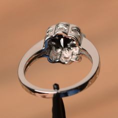 It is natural black spinel ring, the main stone is about 7mm*7mm, round cut, weight about 1.65 carats. The basic metal is sterling silver and plated with rhodium. To change the metal to a solid gold (white/rose) or platinum is also available, please ask for a quotation if you want. You can also go to my shop Home for more elegant rings: https://www.etsy.com/shop/godjewelry?ref=hdr_shop_menu More natural black spinel rings: https://www.etsy.com/shop/godjewelry?ref=seller-platform-mcnav&sectio Flower Ring Wedding, Flower Wedding Ring, Black Spinel Ring, Elegant Rings, Spinel Ring, Ring Flower, Floral Ring, Black Spinel, Elegant Ring