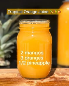 two mangos, 3 oranges and 1 pineapple in a mason jar