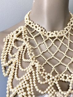 "Pretty faux pearl necklace with all over beads to dress up any look. Beads create a cross cross and drape loop design down the front. Adjustable clasp and chain in gold toned and variety of size beads Measurements: Bib front is 10\" long by 10\" to 5\" wide from top to bottom" Modern Avatar, Pearl Bib Necklace, Chain Body Jewelry, Necklace Gold Chain, Rhinestone Fashion, Cream Wedding, Loop Design, Pearl Cream, Bib Necklaces