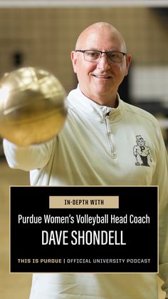 a man holding a basketball in his right hand with the words purdue women's volleyball head coach on it