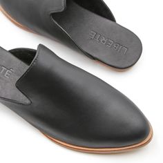 The Modern Mule - Black – Liberté Chic Leather Footbed Slip-on Mules, Sleek Slip-on Mules With Pointed Toe, Modern Leather Slip-ons With Pointed Toe, Modern Flat Heel Mules With Rubber Sole, Modern Mules With Flat Heel And Rubber Sole, Everyday Slip-on Mules With Leather Footbed, Sleek Closed Toe Spring Mules, Sleek Closed Toe Mules For Spring, Chic Leather Slip-on Mules