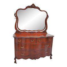 an old dresser with a mirror on top