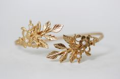 This gorgeous arm band is decorated with a nice variety of leaves, flowers and pearls. Size is around 10inch/25cm. This size could be slightly adjusted to become bigger or smaller. Please measure you arm before to make sure this is a good fit. Otherwise please contact me. * Comes wrapped in a pretty gift bag. * Choose between 14k gold, rose gold or silver plated brass. For updates, new products, one-of-a-kind's, special offers and more- like us on Facebook: https://www.facebook.com/avigailadamje Adjustable Flower-shaped Bangle For Weddings, Adjustable Flower Bangle For Wedding, Gold Flower Pearl Bracelet For Wedding, Elegant Flower Shaped Wedding Bangle, Delicate Floral Pearl Bracelet For Wedding, Delicate Flower-shaped Pearl Bracelet For Wedding, Bridal Jewerly, Bridesmaid Bracelets, Gold Leaf Crown