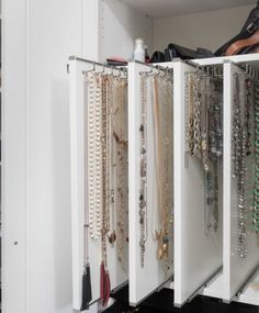 a closet filled with lots of necklaces and bracelets