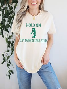 Hold On, I'm Overstimulated, Unisex Graphic Tee, Funny Bear T Shirt, Oversized Tee Shirt, Comfort Colors® Shirt, Funny T Shirt, Meme Shirt  F I T ∙ & ∙ S I Z I N G : -->These Unisex T-shirts have a modern-fit. Consult the size chart in the pics for an accurate fit. -->Women's sizes are narrower than the waist. -->Sleeves are rolled up in some product pictures. They do not come rolled up on delivery. T I M E ∙ T O ∙ D E L I V E R Y : -->Processing and production time is 1-2 business days. -->Deli Oversized Tee Shirt, Shirt Quotes, Funny Bears, My Pleasure, Comfort Colors Shirt, Bear T Shirt, T Shirt Oversized, Product Pictures, Oversized Tee