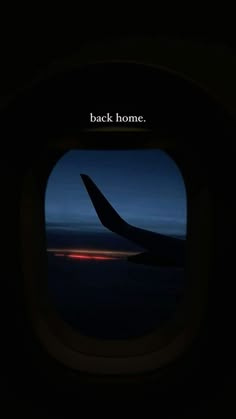 an airplane window with the words back home on it's side at night time