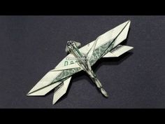 an origami airplane made out of dollar bills