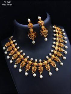 a necklace and earring set with pearls