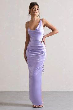 a woman in a purple dress posing for the camera