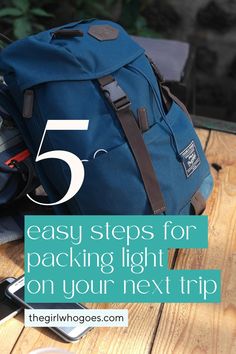 a blue backpack sitting on top of a wooden table with text overlay reading 5 easy steps for packing light on your next trip