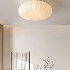 a living room filled with furniture and a white vase on top of a wooden table